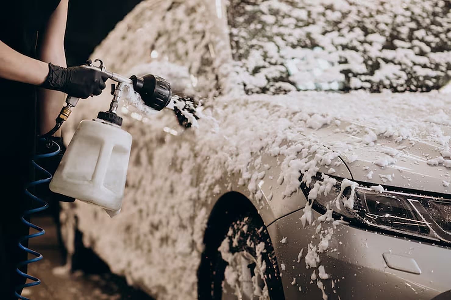 Snow foam being applied to a car with a foam lance